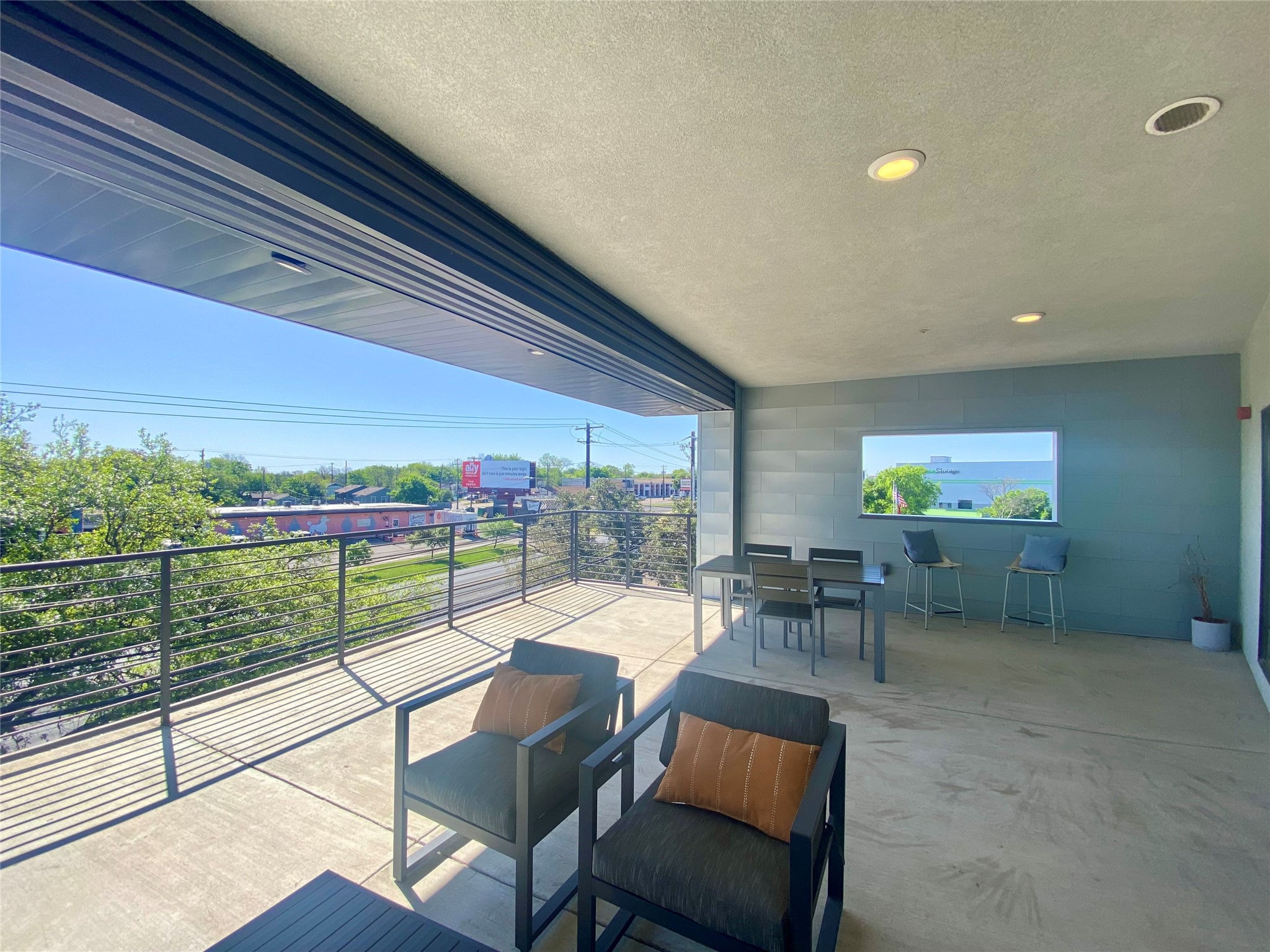 6444 Burnet Road, Unit 203 Austin, TX 78757 - Photo 29 of 30 Expansive outdoor living space with a concrete floor, metal railings, and recessed lighting