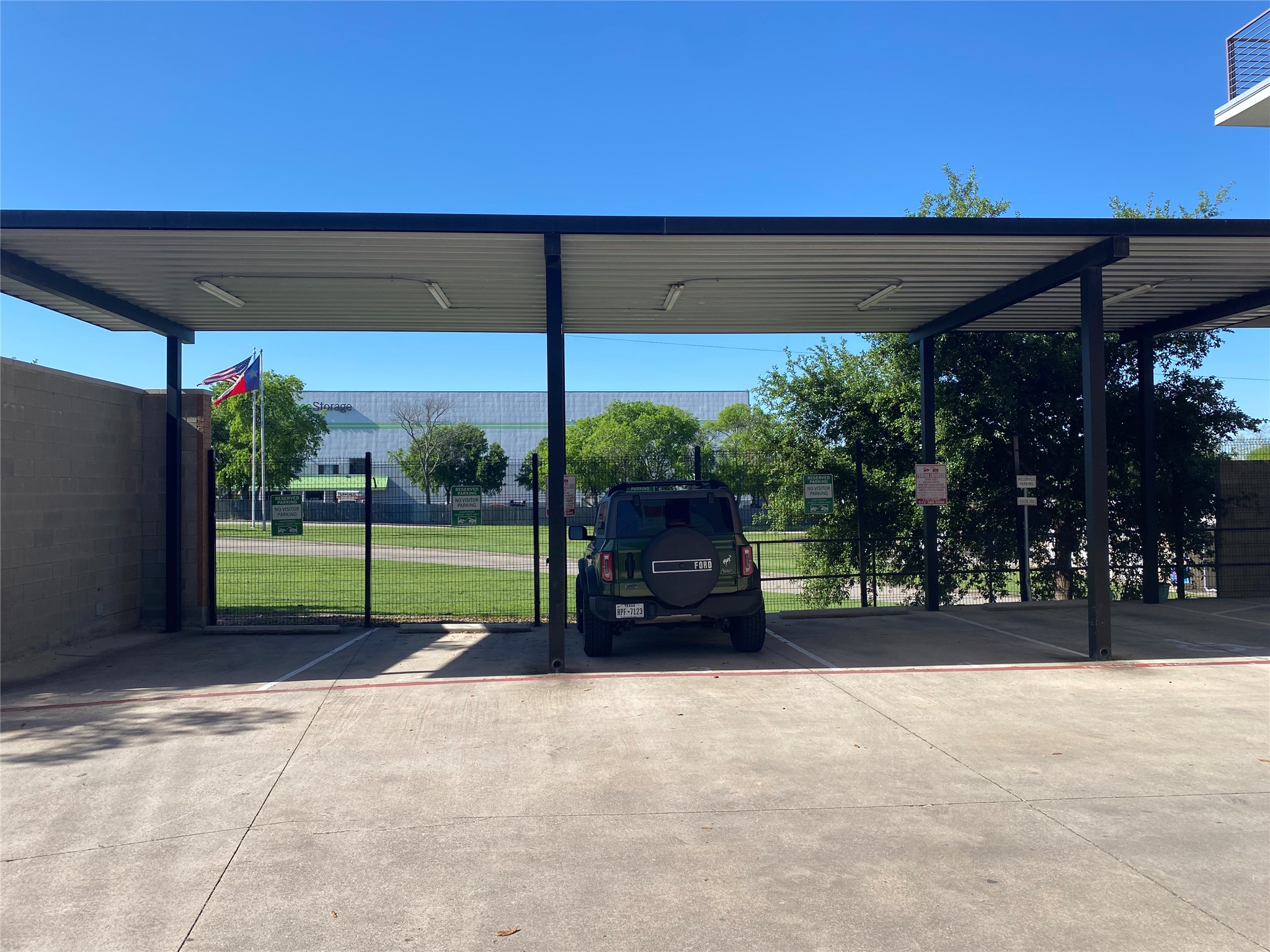 6444 Burnet Road, Unit 203 Austin, TX 78757 - Photo 30 of 30 Covered parking space with concrete flooring and overhead lighting