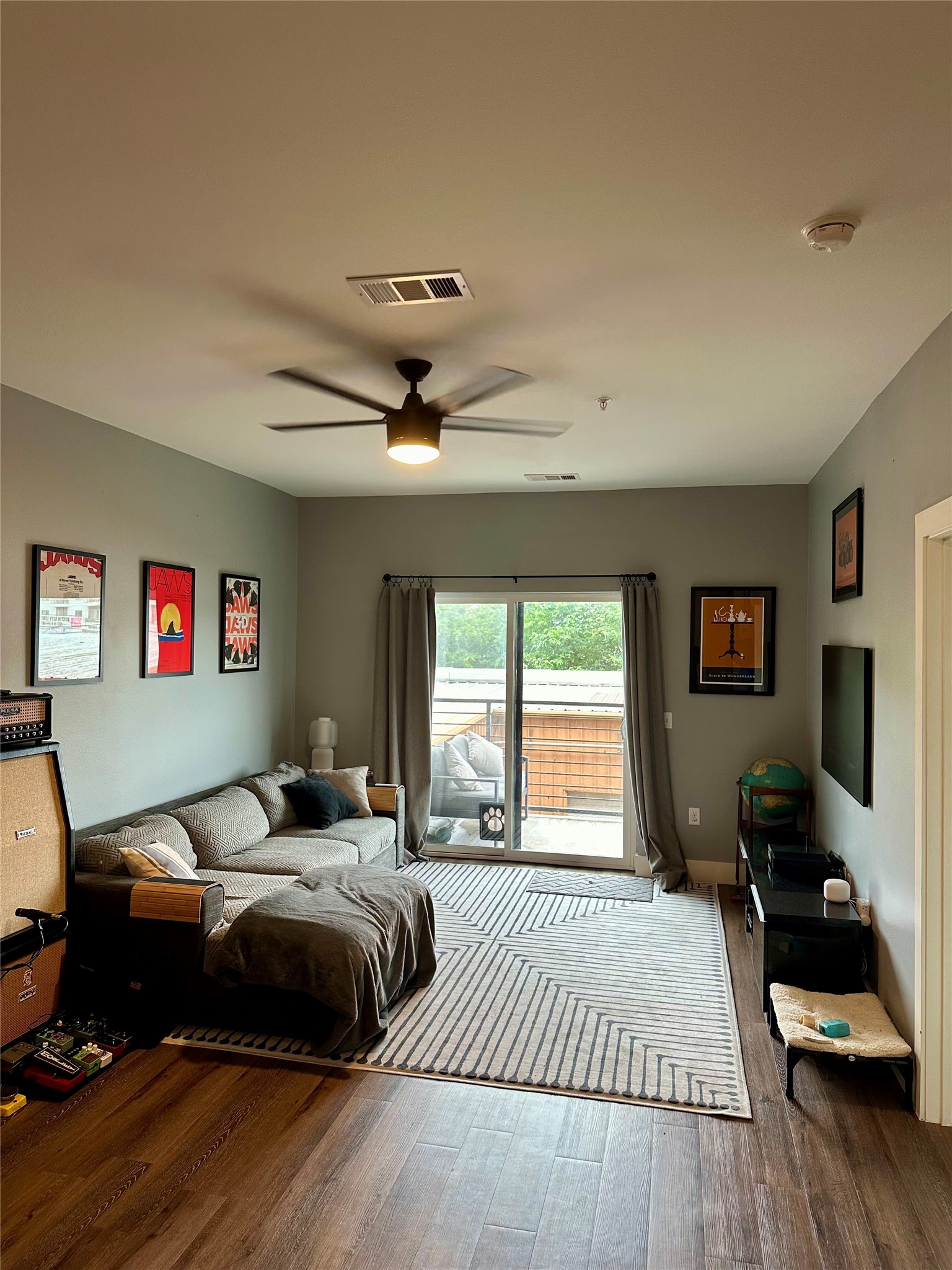 6444 Burnet Road, Unit 203 Austin, TX 78757 - Photo 9 of 30 The living area features hardwood style flooring and a ceiling fan with integrated lighting
