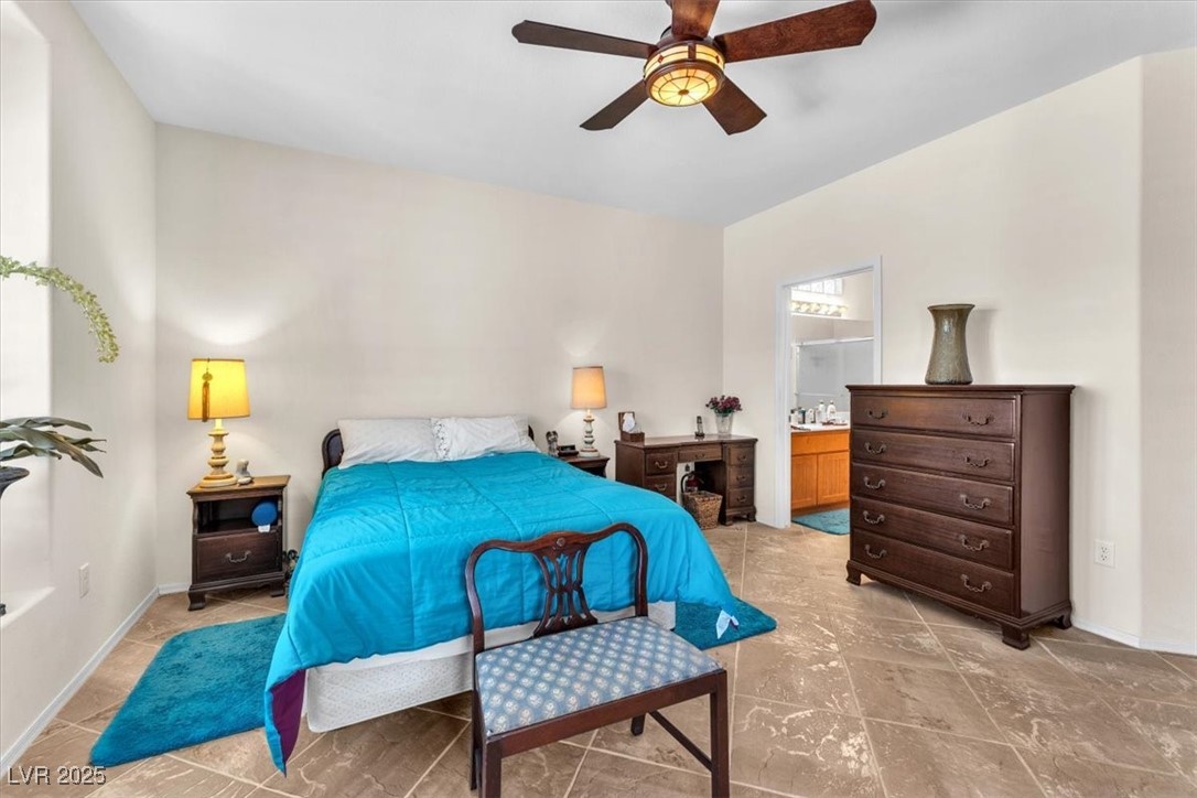 3056 Monroe Park Road Henderson, NV 89052 - Photo 11 of 28 Bedroom with a ceiling fan, baseboards, and ensuite bath