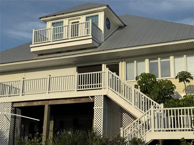 a view of a house with wooden deck