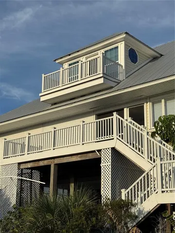 a view of a house with wooden deck