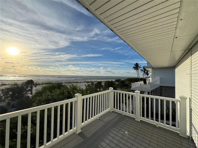 a view of a balcony with wooden floor
