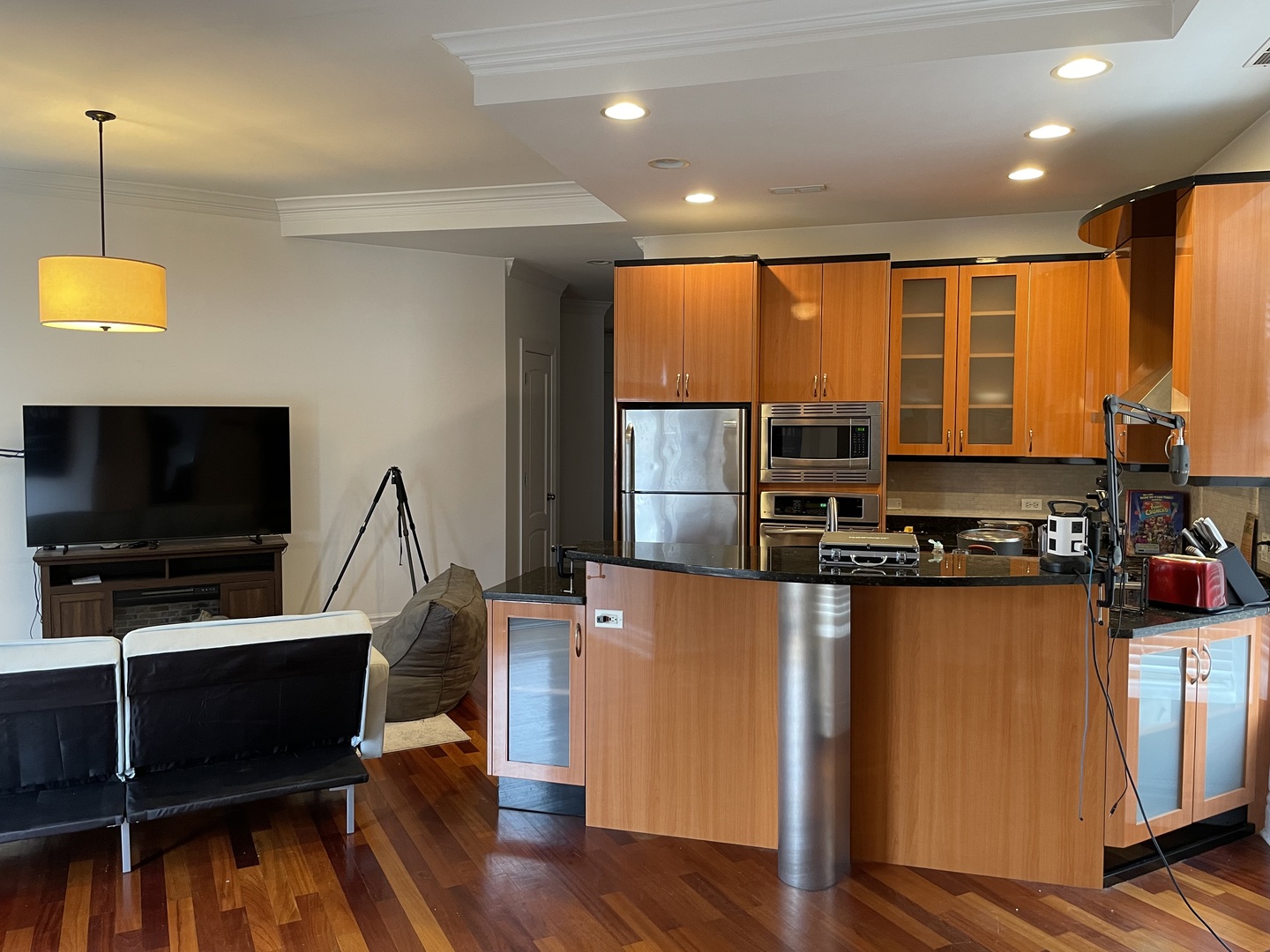 36 South Ashland Avenue, Unit 501 Chicago, IL 60607 - Photo 5 of 12 a living room with furniture a flat screen tv and floor to ceiling window