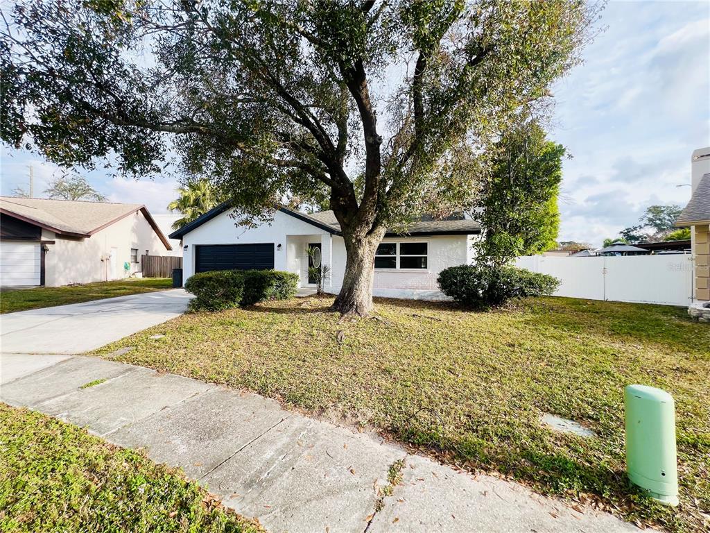 12195 71st Way Largo, FL 33773 - Photo 2 of 31 a front view of a house with a yard