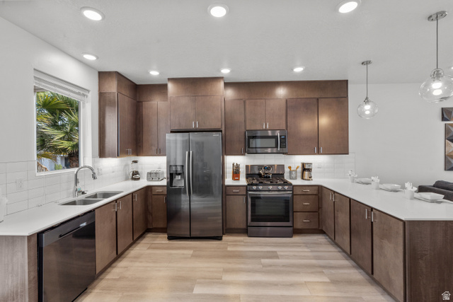 1122 South 1790th West, Unit 1 St. George, UT 84770 - Photo 8 of 37 Kitchen featuring wood-finish flooring, white countertops, subway tile backsplash, recessed lighting, and stainless steel appliances