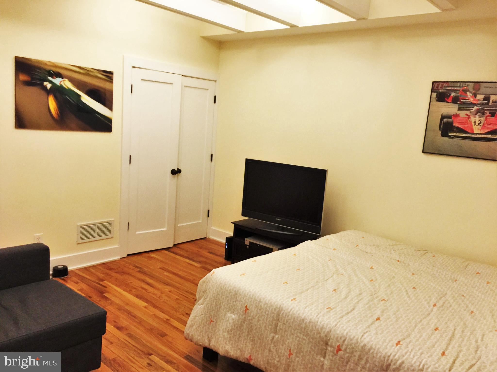 170 Grape Street, Unit LOWR Philadelphia, PA 19127 - Photo 2 of 5 a bedroom with a bed and wooden floor