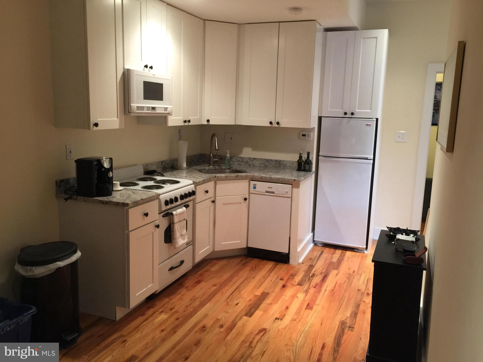 170 Grape Street, Unit LOWR Philadelphia, PA 19127 - Photo 3 of 5 a kitchen with white cabinets and white appliances