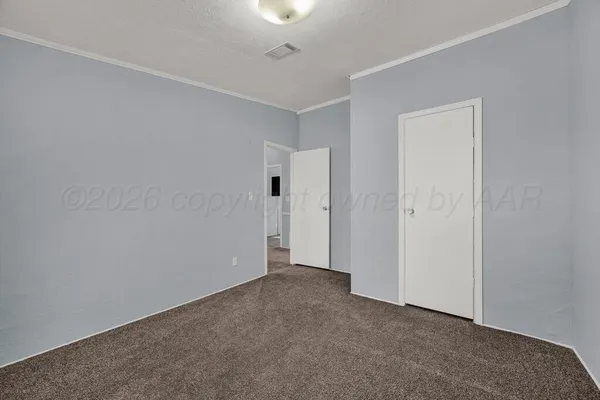 a view of an empty room and closet area