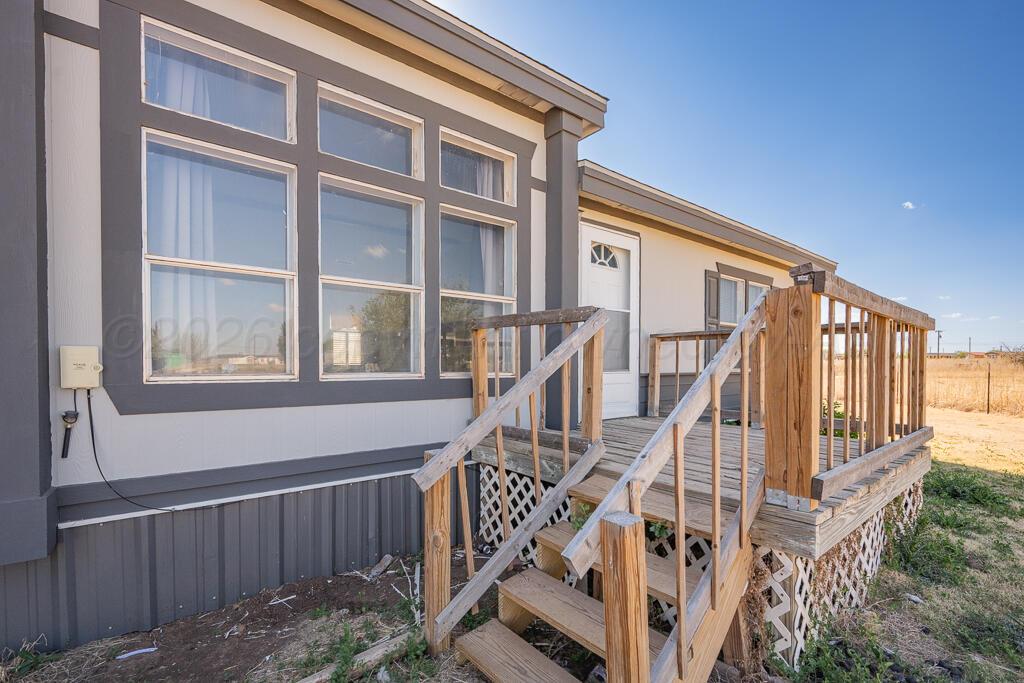 17650 Krabbe Street Canyon, TX 79015 - Photo 2 of 29 a view of staircase with lots of windows and wooden fence