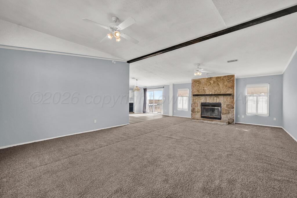 17650 Krabbe Street Canyon, TX 79015 - Photo 6 of 29 an empty room with fireplace and windows