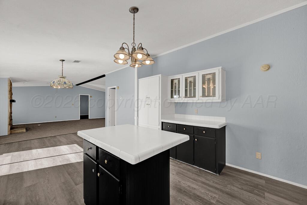 17650 Krabbe Street Canyon, TX 79015 - Photo 9 of 29 a kitchen with a center island wooden floor and cabinets