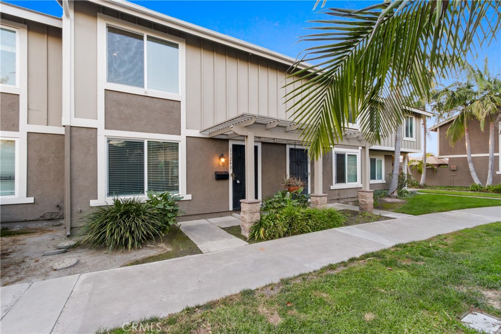 11240 Dover Way Stanton, CA 90680 - Photo 1 of 1 a front view of a house with a garden