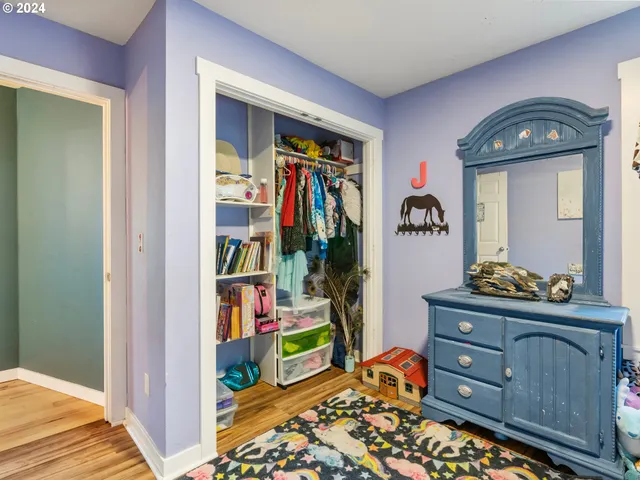 a bedroom with a bed and dresser