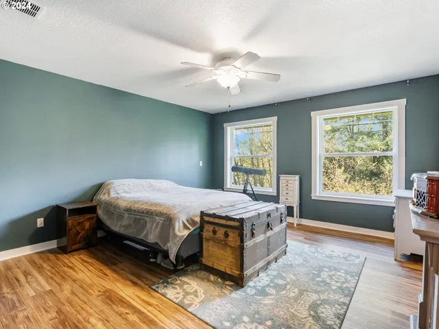 a bedroom with a bed dresser and a window