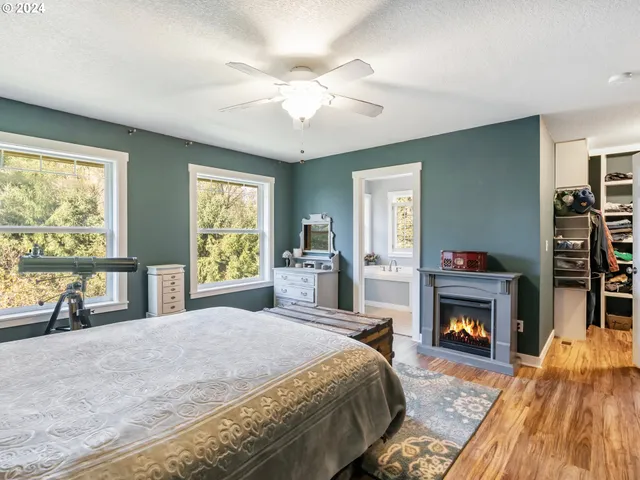 a spacious bedroom with a bed and a fireplace