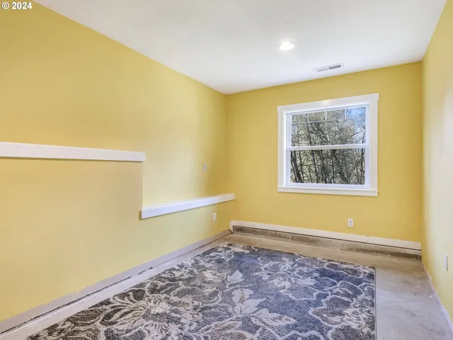 a view of room with wooden floor