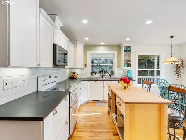 a kitchen with a sink a counter top space and stainless steel appliances