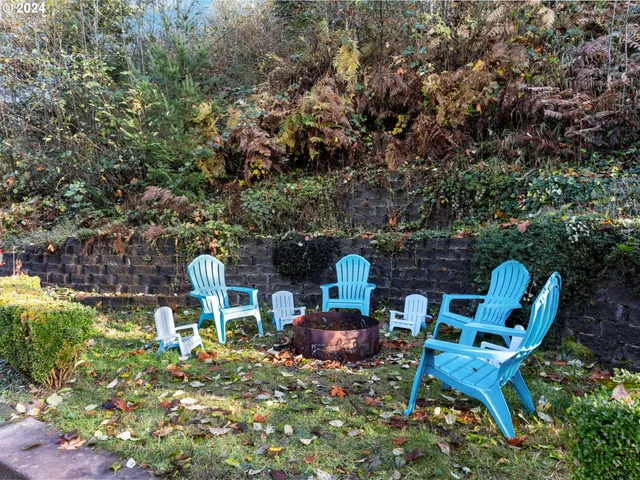 a view of a house with a yard and wooden deck
