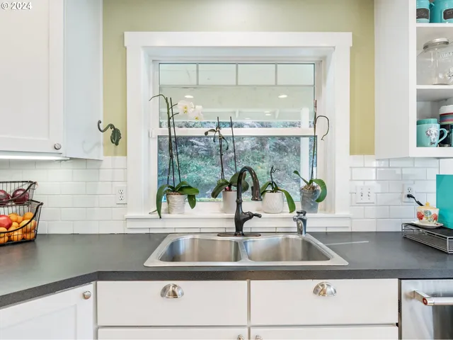a view of a kitchen counter top a sink and a window