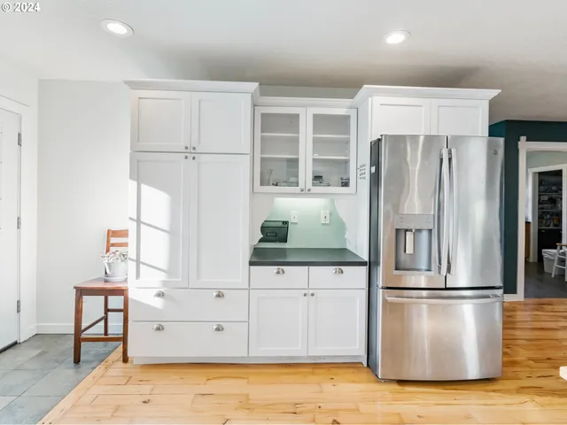a kitchen with stainless steel appliances a refrigerator sink and cabinets