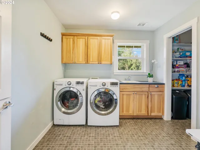 a utility room with sink dryer and washer