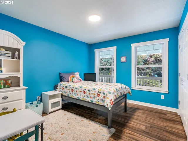 a bedroom with a bed table and a window