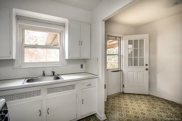 a kitchen with a sink cabinets and window