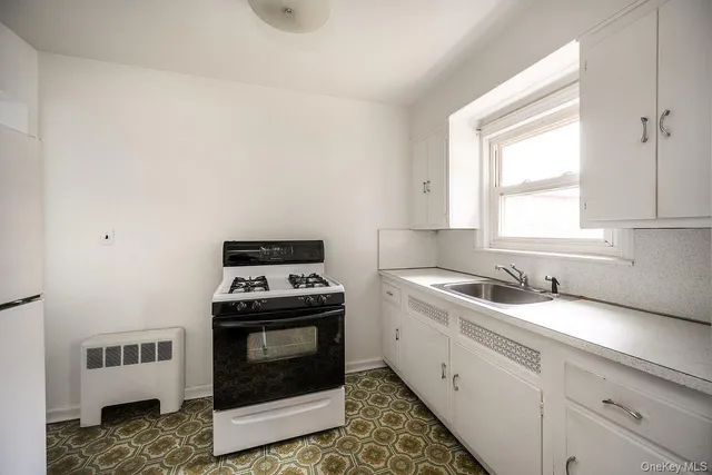 a kitchen with a stove and a sink