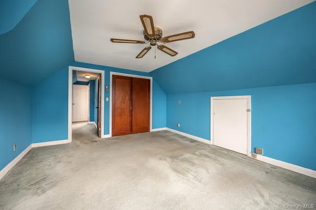a view of a livingroom with a ceiling fan and window