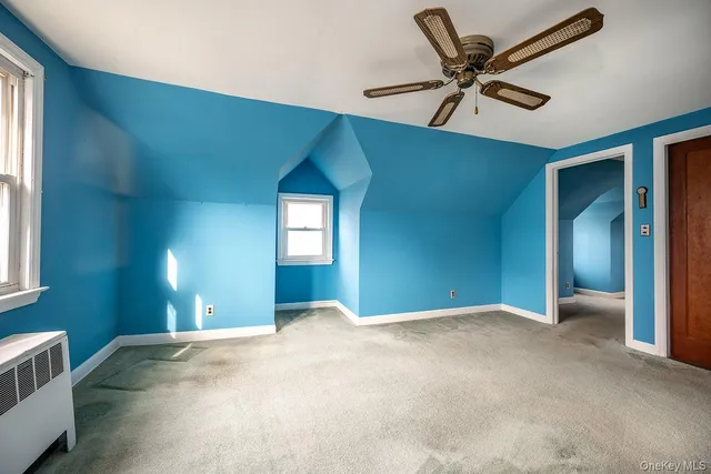 a view of a livingroom with a ceiling fan and window