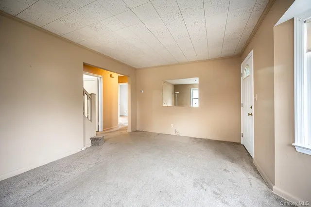 an empty room with windows and closet