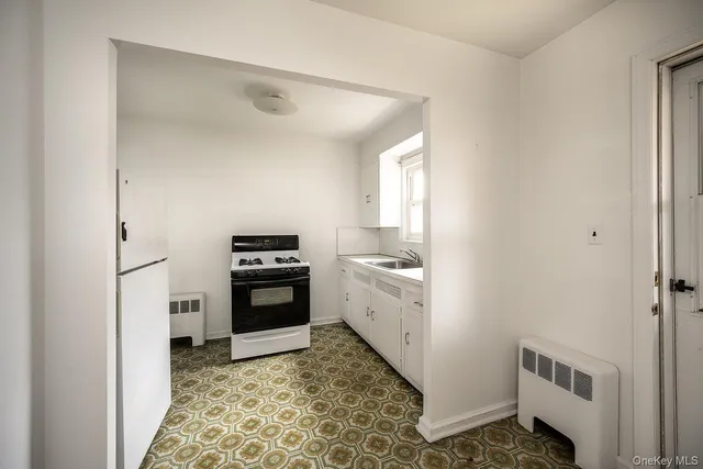 a kitchen with granite countertop a refrigerator and a stove