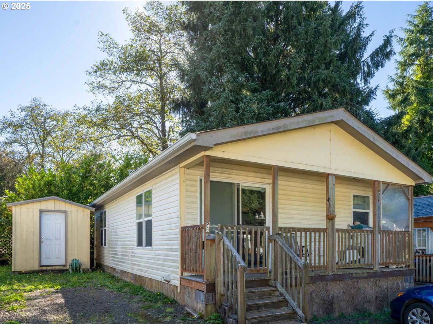 4850 Netarts Highway, Unit 6 Tillamook, OR 97141 - Photo 1 of 14 a view of a house with a yard and plants