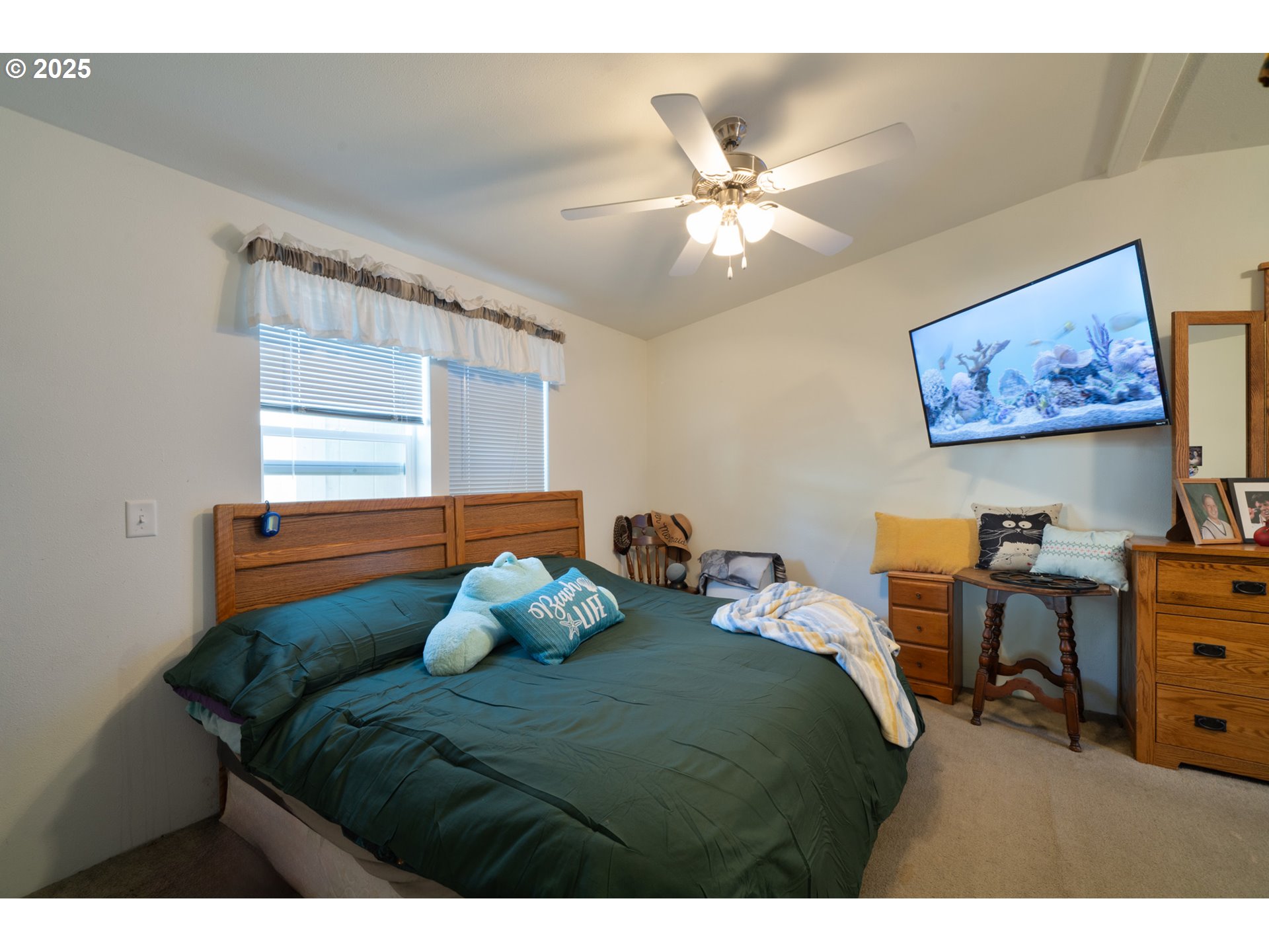 4850 Netarts Highway, Unit 6 Tillamook, OR 97141 - Photo 12 of 14 a bedroom with a bed and a chandelier