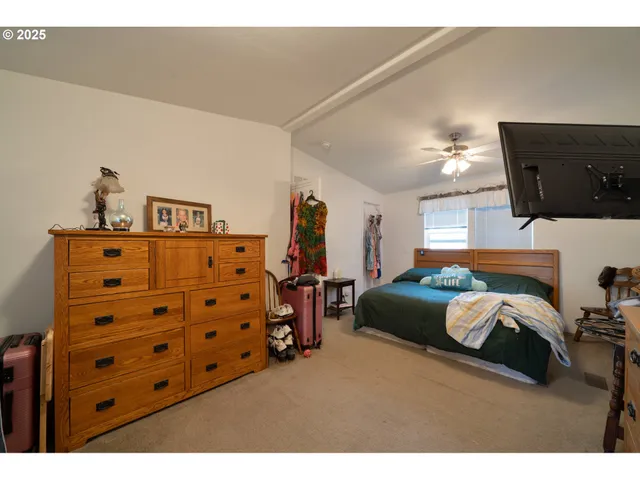 a bedroom with furniture and a flat screen tv