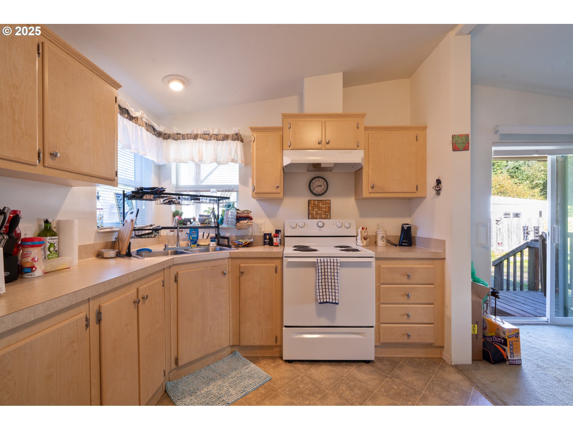 4850 Netarts Highway, Unit 6 Tillamook, OR 97141 - Photo 8 of 14 a kitchen with a sink a stove and cabinets