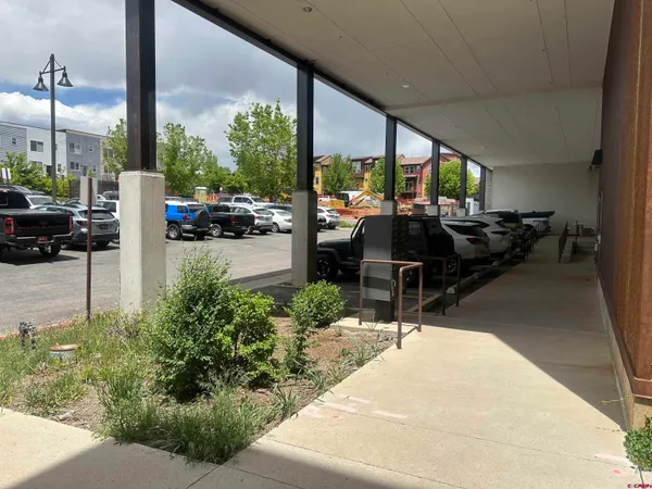 a building outdoor space with patio furniture and potted plants