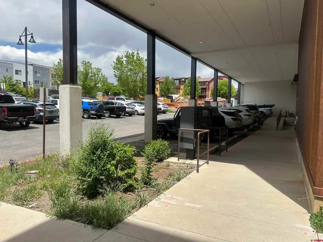 a building outdoor space with patio furniture and potted plants