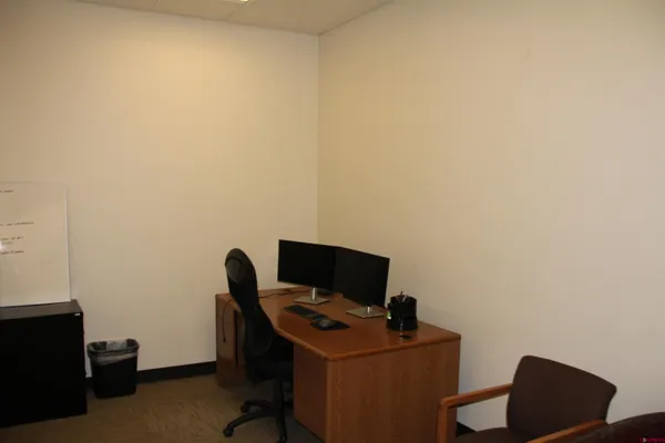 a view of a workspace with furniture