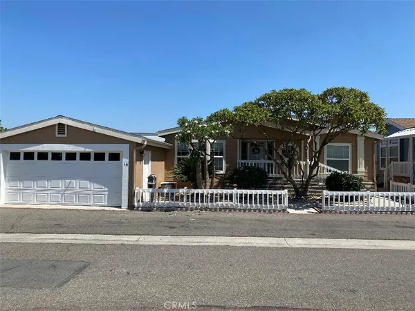 a view of a house with a small yard and plants