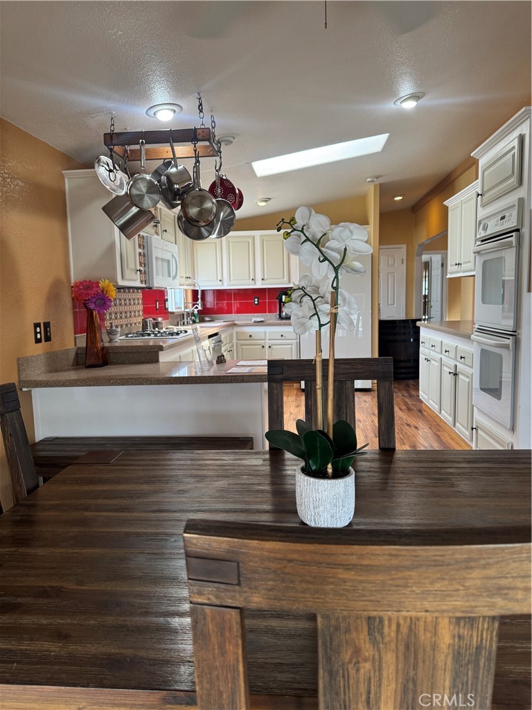 16 Magnolia Anaheim, CA 92801 - Photo 11 of 25 a kitchen with refrigerator and microwave