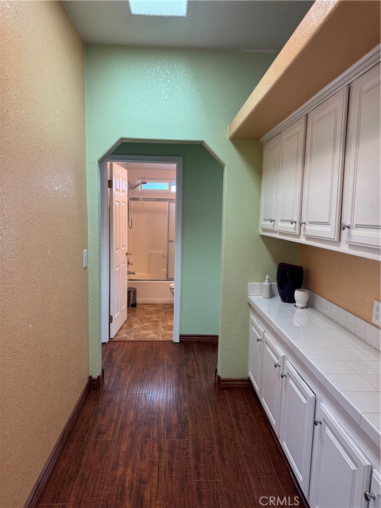 16 Magnolia Anaheim, CA 92801 - Photo 14 of 25 a hallway with cabinets and wooden floor