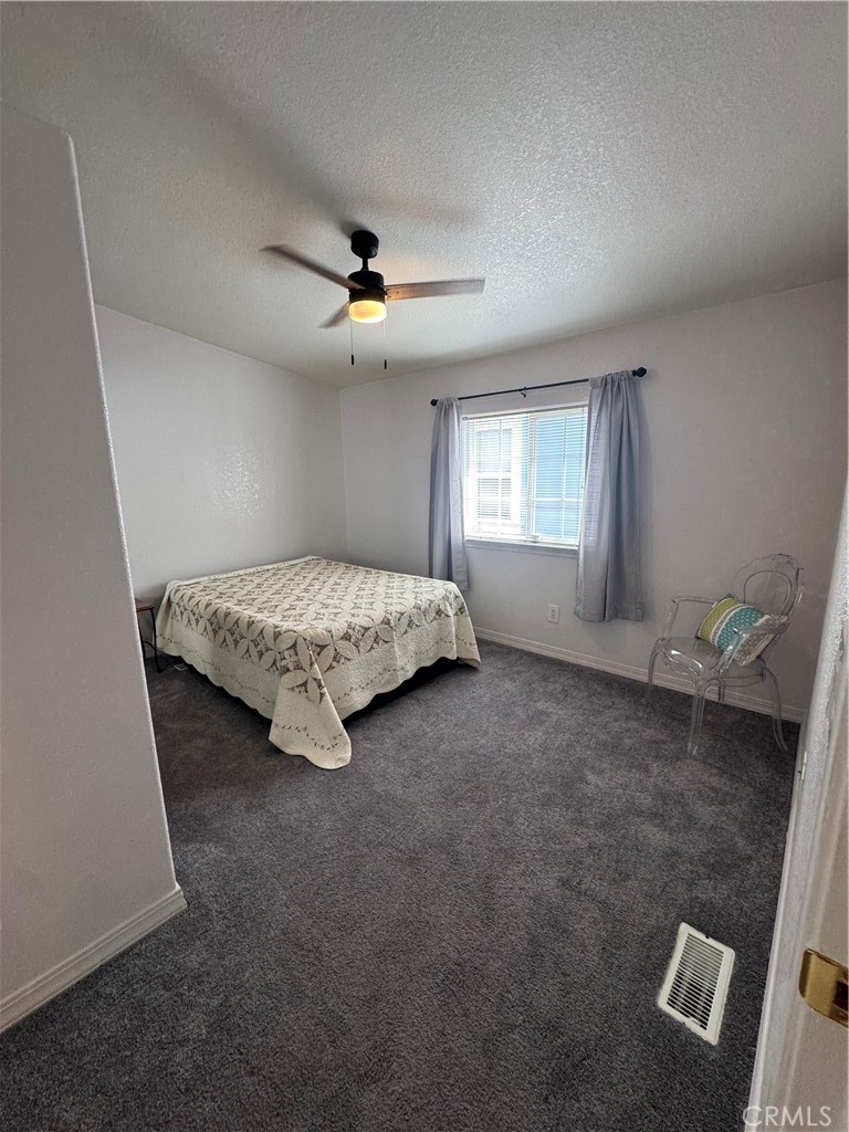 16 Magnolia Anaheim, CA 92801 - Photo 18 of 25 a spacious bedroom with a bed and a chandelier