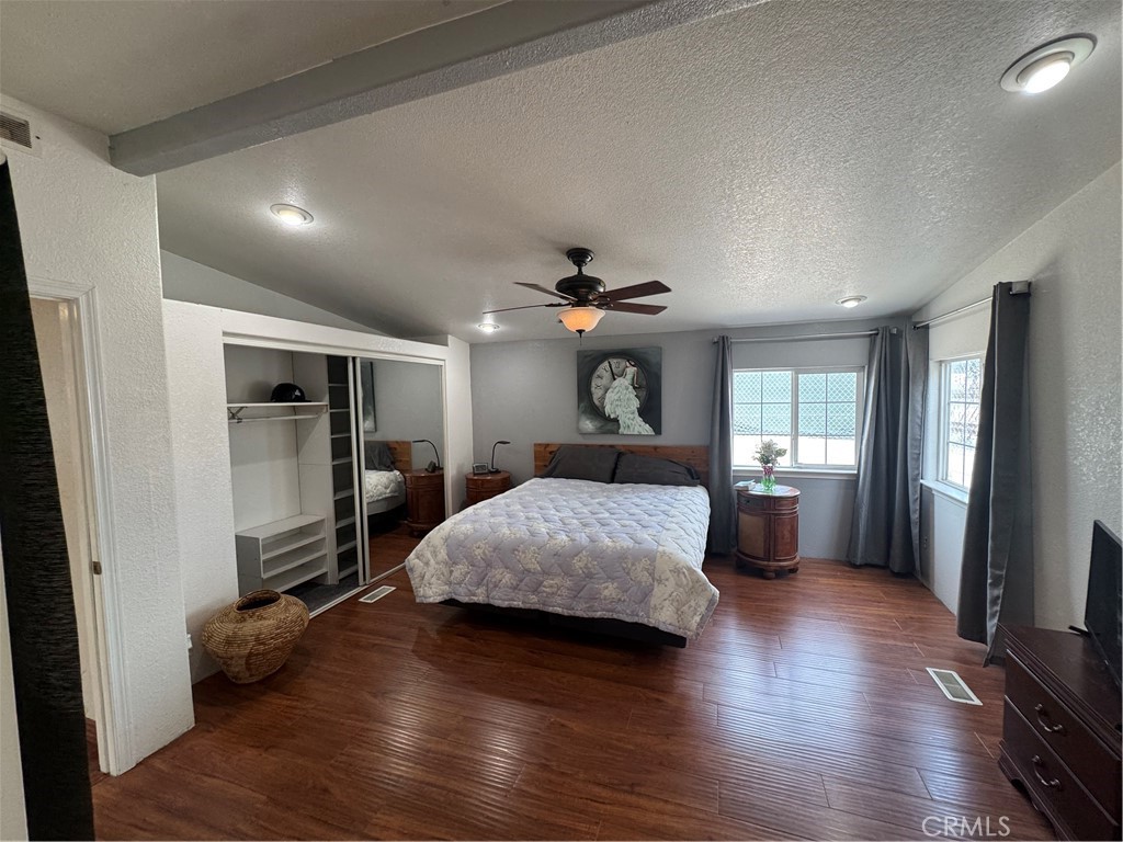 16 Magnolia Anaheim, CA 92801 - Photo 19 of 25 a bedroom with a bed and a large mirror with wooden floor