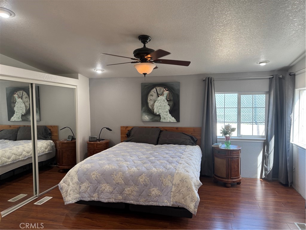 16 Magnolia Anaheim, CA 92801 - Photo 20 of 25 a bedroom with a bed and a chandelier