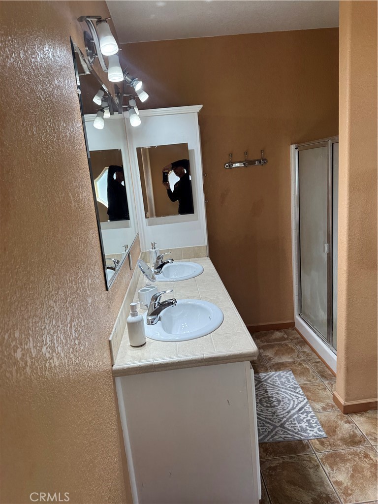 16 Magnolia Anaheim, CA 92801 - Photo 23 of 25 a bathroom with a sink a large mirror and vanity
