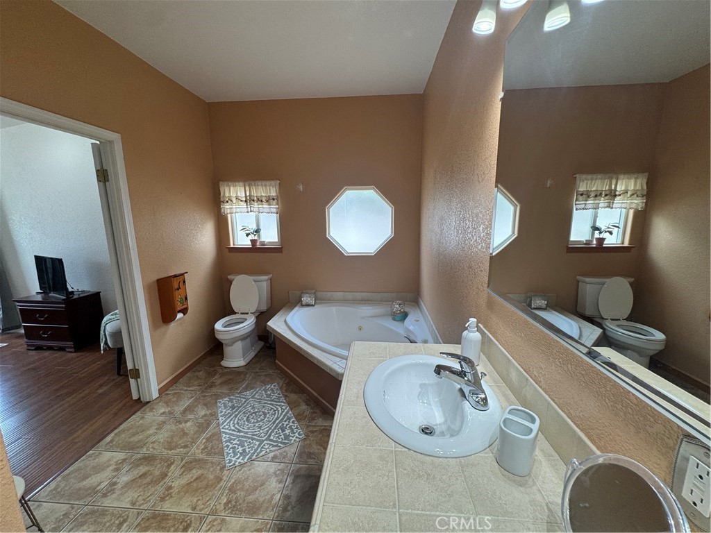 16 Magnolia Anaheim, CA 92801 - Photo 24 of 25 a spacious bathroom with a granite countertop sink and a mirror