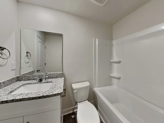 a bathroom with a toilet and bathtub