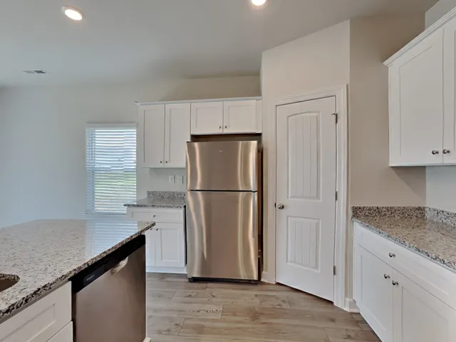 a kitchen with a refrigerator and a sink